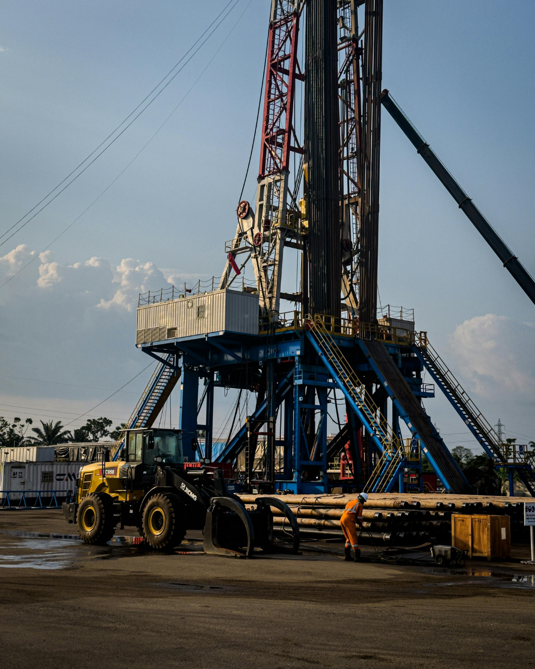 a construction site with a crane and a large tower