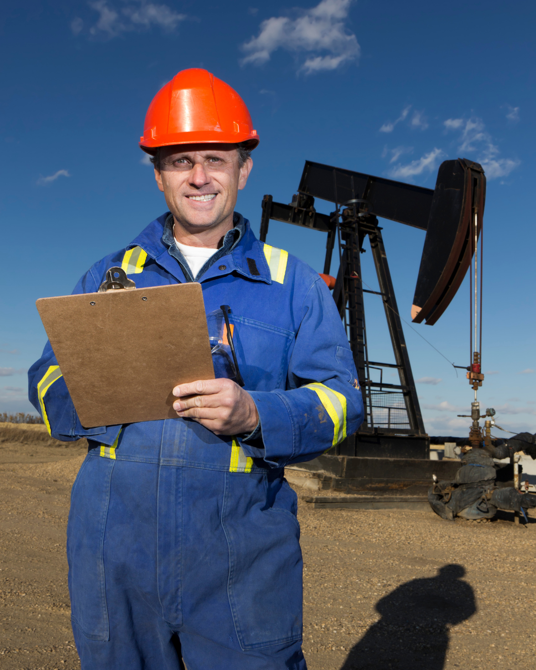 a man in a hard hat holding a clipboard