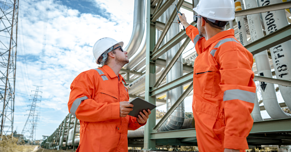 a group of men wearing orange jumpsuits and helmets